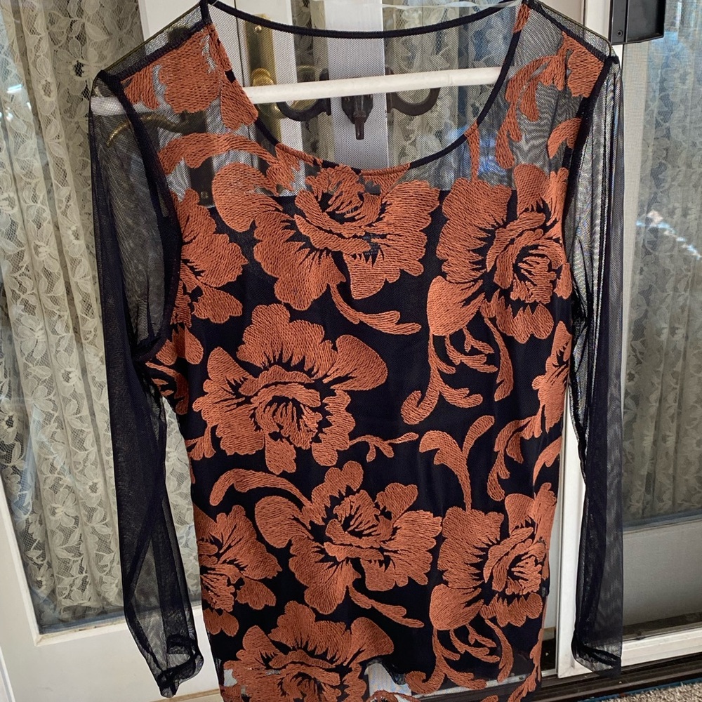 Size L women’s INC top.